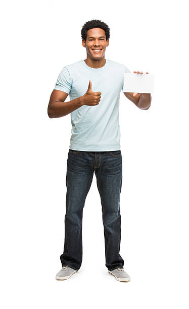 istock Young latin man in casual clothes holding postcard 477719461