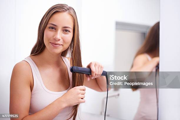 Getting That Sleek Look Stock Photo - Download Image Now - Hair Straighteners, Women, One Woman Only