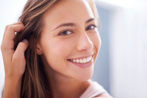A young woman smiling at the camera - closeup