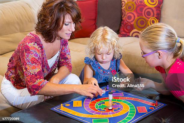 Mutter Und Zwei Kinder Spielen Ein Brettspiel Zu Hause Fühlen Stockfoto und mehr Bilder von Brettspiel
