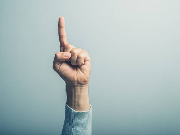 Male hand with finger pointing up stock photo