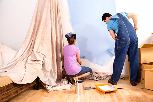 istock Construction: Latin couple. Home improvement projects. Painting a wall. 477720577
