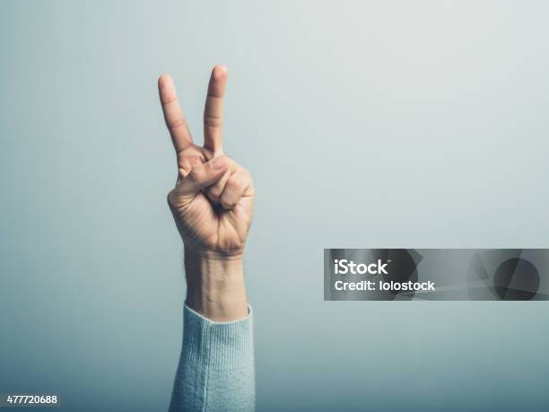 Male Hand Displaying Victory Sign Stock Photo - Download Image Now - Symbols Of Peace, Number 2, Symmetry