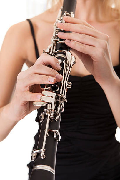 istock Beautiful young woman playing clarinet 477720734