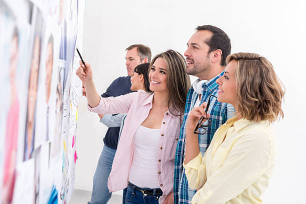 istock Group of business people looking at a wall chart 477720994
