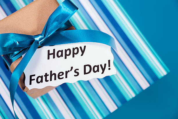 istock Holidays:  Father's Day gift for dad on blue, striped background. 477721575