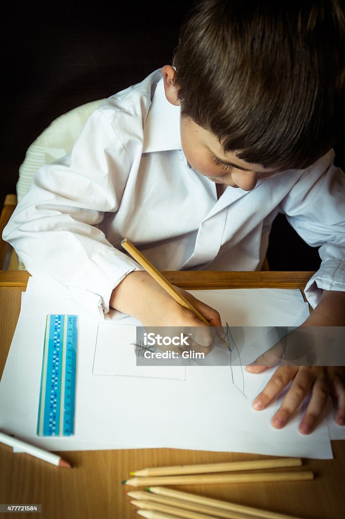 Drawing Boy In Front Of Desk. Small Boy in front of Desk. 2015 Stock Photo