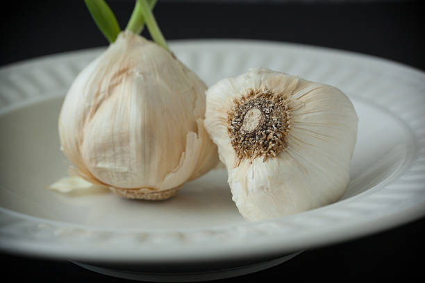 istock Garlic Bulbs on Whie Plate 477722226