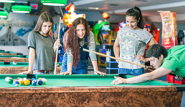 istock Young friends playing pool-game or billiard 477722366