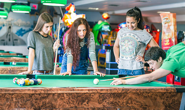 istock Young friends playing pool-game or billiard 477722368
