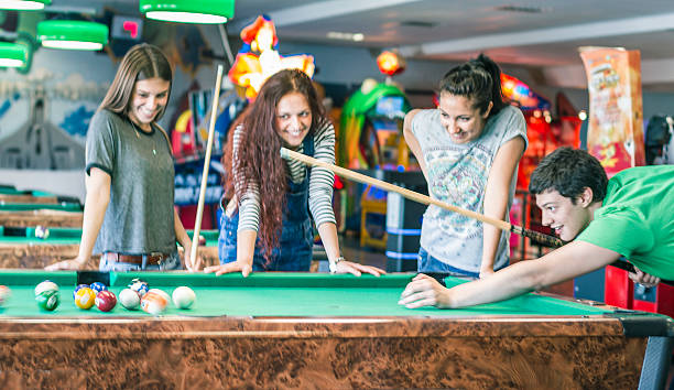 istock Young friends playing pool-game or billiard 477722372