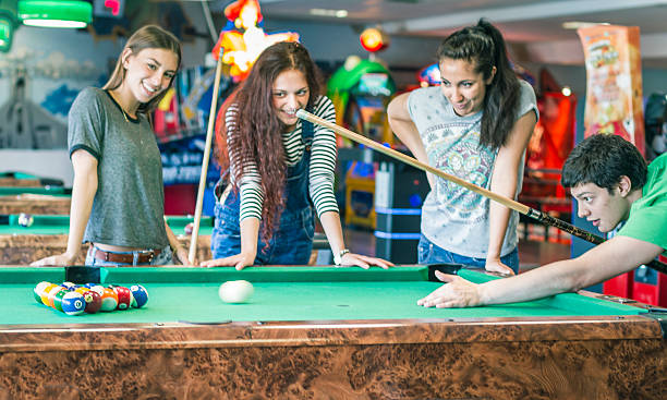 istock Young friends playing pool-game or billiard 477722374