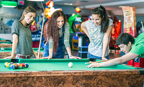 istock Young friends playing pool-game or billiard 477722378
