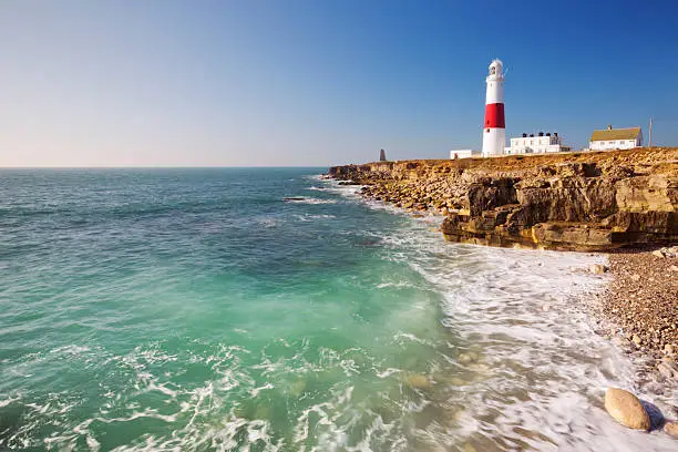 The Portland Bill Lighthouse on the Isle of Portland in Dorset, England on a sunny day.