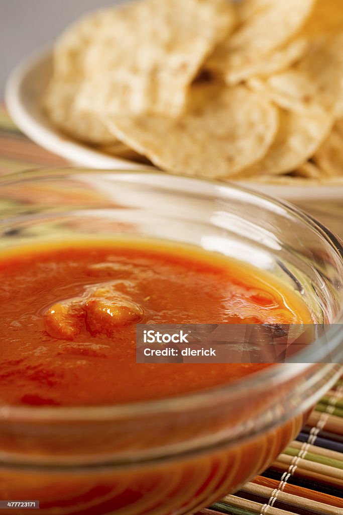 Two bowls of corn chips and red salsa. See more images in this series below: Close-up Stock Photo