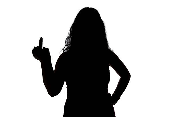 istock Photo of woman's silhouette showing middle finger 477723632