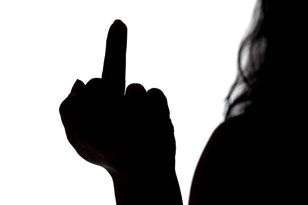 istock Silhouette of woman showing middle finger 477723634