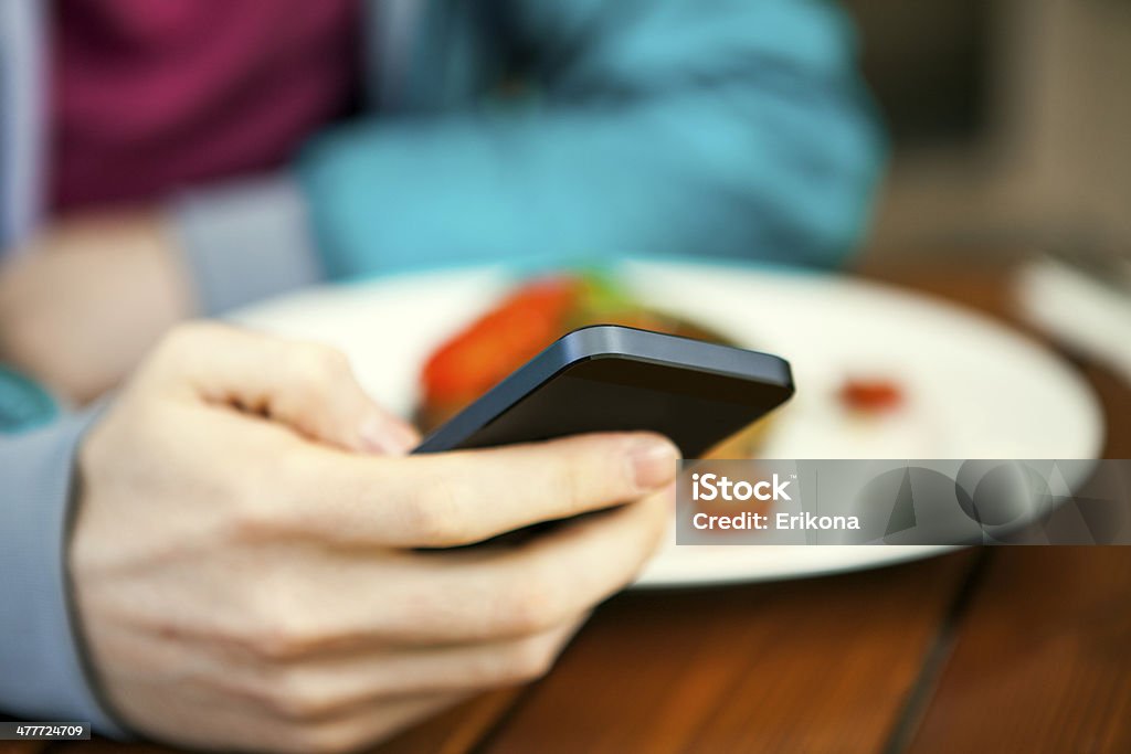 Man uses smart phone Man uses smart phone in cafe Adult Stock Photo