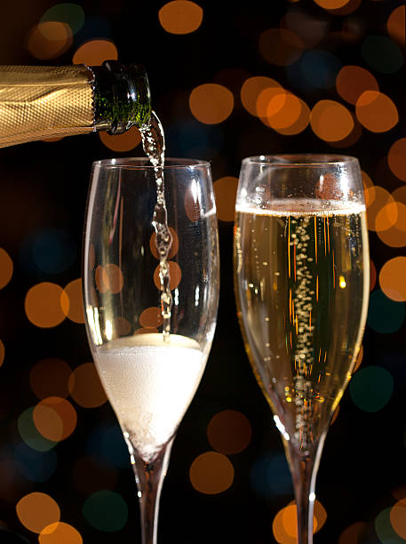 Champagne pouring into glass stock photo