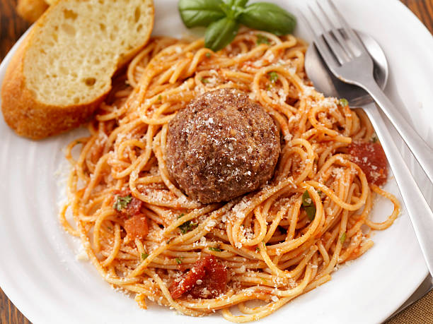 Spaghetti with Large Meatballs Spaghetti with Large Meatballs in a Tomato Basil Sauce with freshly grated Parmesan cheese -Photographed on Hasselblad H3-22mb Camera big plate of food stock pictures, royalty-free photos & images