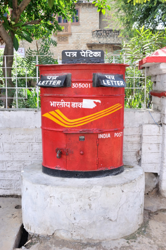Ajmer, India - September 24, 2013: red postbox outside the India post office, Ajmer, Rajasthan, India.