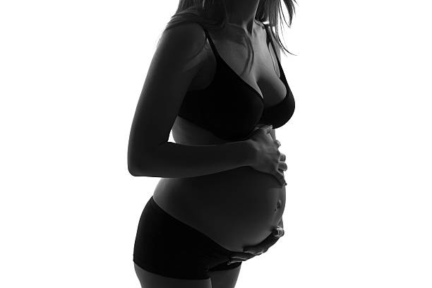 istock Pregnant woman with hands over tummy 477727071