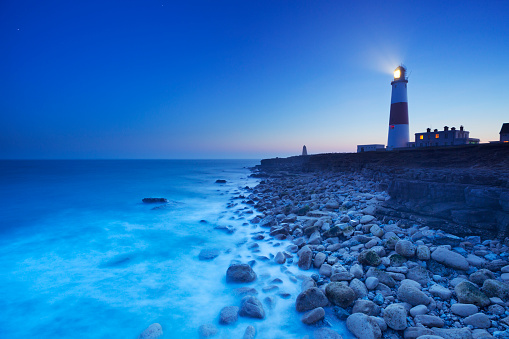 The Portland Bill Lighthouse on the Isle of Portland in Dorset, England at night.