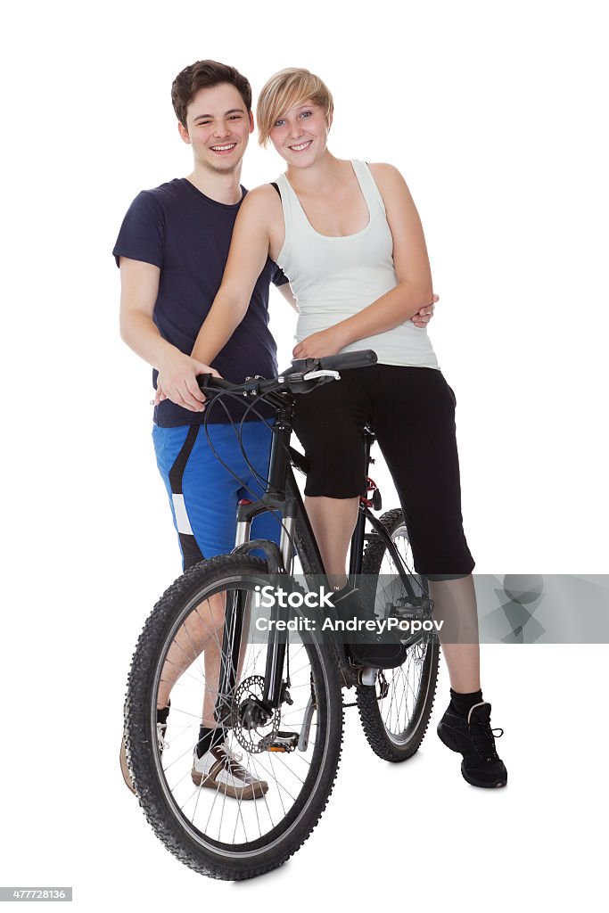 Fit healthy young couple Fit healthy young couple who enjoy an active outdoor lifestyle standing with  bicycle Bicycle Stock Photo