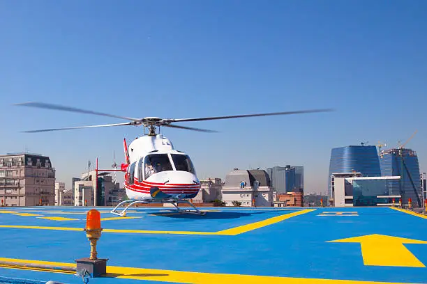 Helicopter sits on the helipad of a building in Sao Paulo Brazil