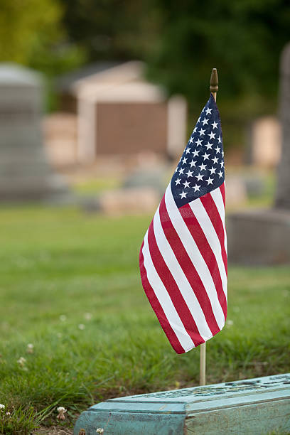 istock American Flag On US Veteran Grave 477728778