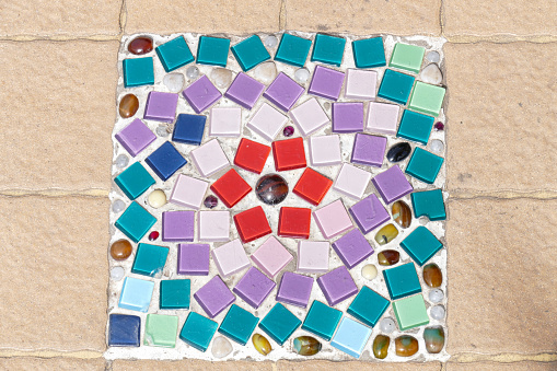 the art design of colorful stone and mosaic tile decorating on temple floor for abstract background