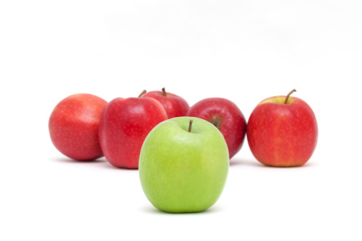 One green and some red apples isolated on white