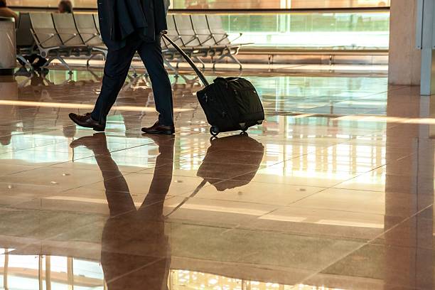 istock people with luggage in airport 477732661