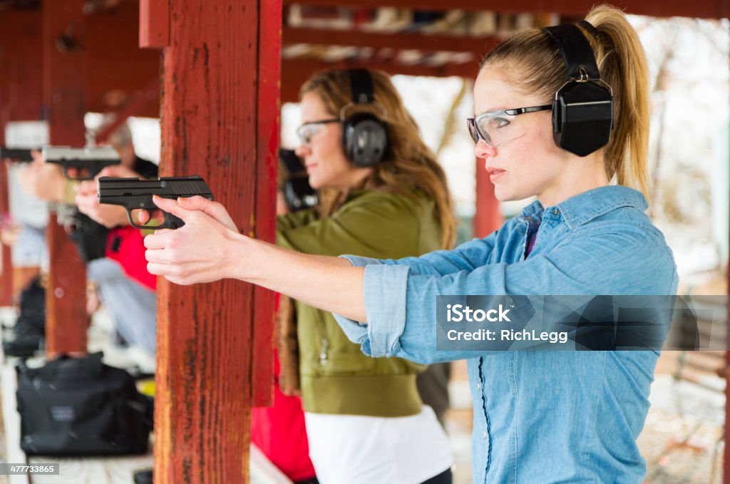 Practicing at the Shooting Range A woman practicing at the gun range. Photographed on location at a shooting range. Target Shooting Stock Photo