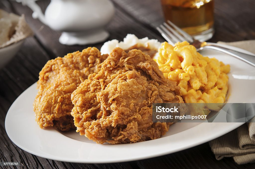 Fried Chicken Fried chicken with macaroni and cheese, mashed potatoes with gravy and sweat tea.  Please see my portfolio for other food and drink images. Fried Chicken Stock Photo