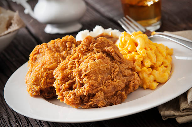 Fried Chicken Fried chicken with macaroni and cheese, mashed potatoes with gravy and sweat tea.  Please see my portfolio for other food and drink images. fried chicken stock pictures, royalty-free photos & images