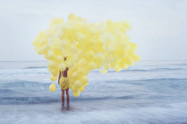 istock girl with yellow balloons 477735769