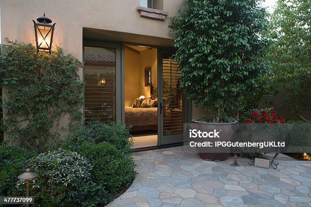 Crazy Paving And Plants With View Into Bedroom Stock Photo - Download Image Now - Luxury, Front Yard, California