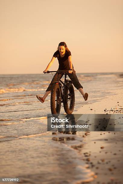 Young Woman Having A Great Time Riding On The Beach Stock Photo - Download Image Now