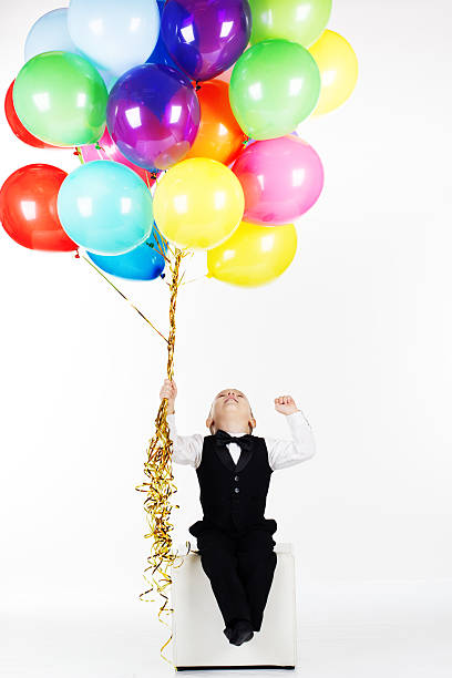 istock Little happy boy holding colorful balloons 477742666