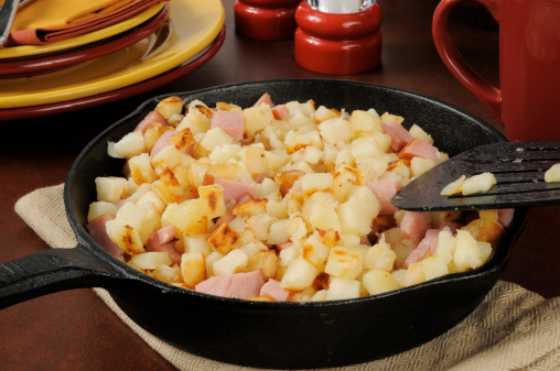 Southern style hash browns with ham in a cast iron skillet