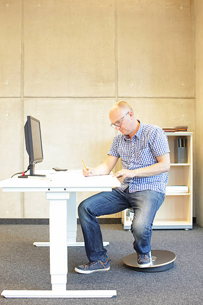 istock middle age man in bad sitting position on seat 477743700