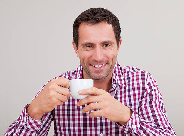 istock Portrait Of Young Man Drinking Having Breakfast 477749330