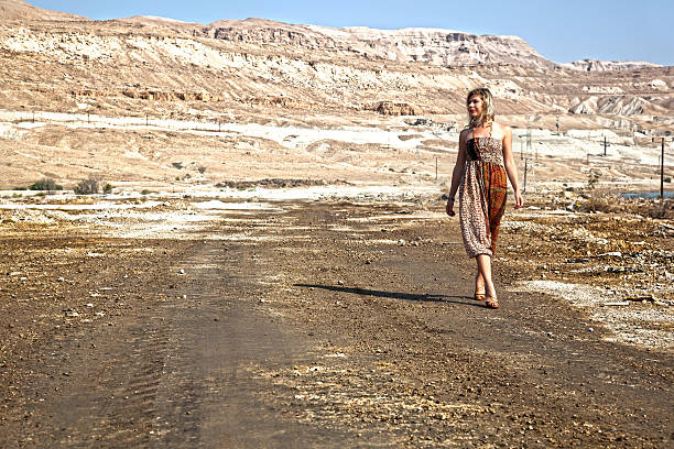 istock Woman walking in the dessert 477749566
