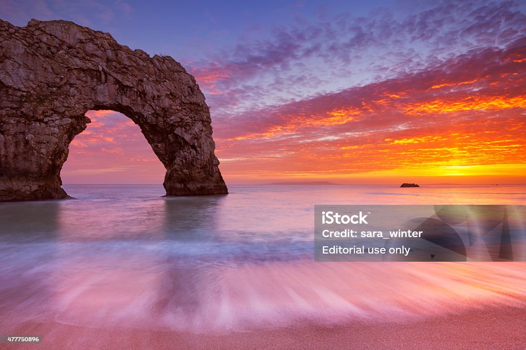 Durdle Door rock arch in Southern England at sunset The Durdle Door rock arch on the Dorset Coast of Southern England at sunset. Durdle Door Stock Photo