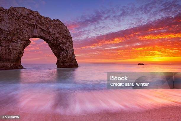 Durdle Door Rock Arch In Southern England At Sunset Stock Photo - Download Image Now