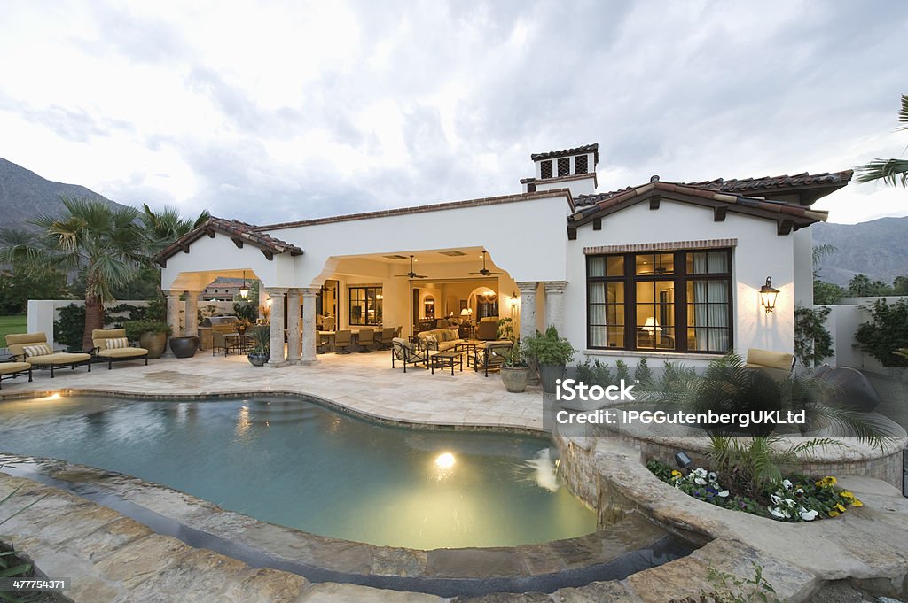 Pool And Modern Home Exterior View of swimming pool and modern home exterior Luxury Stock Photo