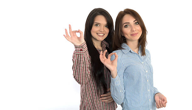 istock Two cheerful girls makes OK hand sign 477755204