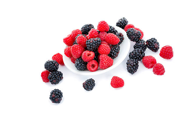 istock Fresh Raspberries and Blackberries on White 477756869
