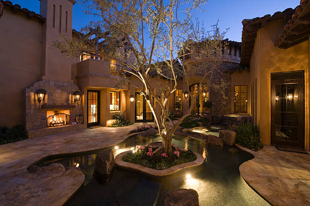 istock Lit House And Pond In Courtyard 477759253
